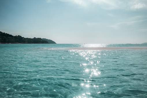 Emerald sea wave sunlight reflection