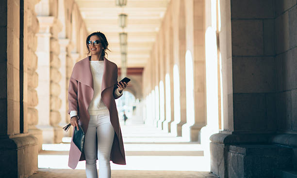 istock Beautiful elegant woman texting outdoors 638112838