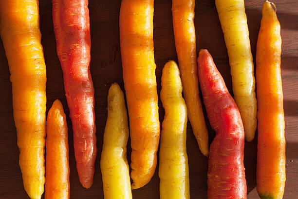 istock raw colorful carrot vegetable on wooden background 638113074