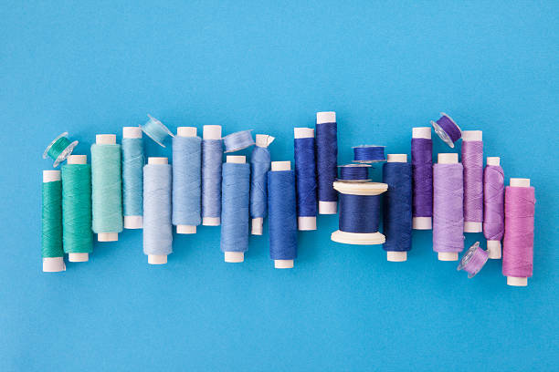 Colorful yarn for sewing Colorful cotton yarns in shades of blue for sewing shades of blue stock pictures, royalty-free photos & images