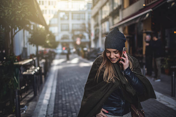 istock Woman using smart phone on the street 638115380