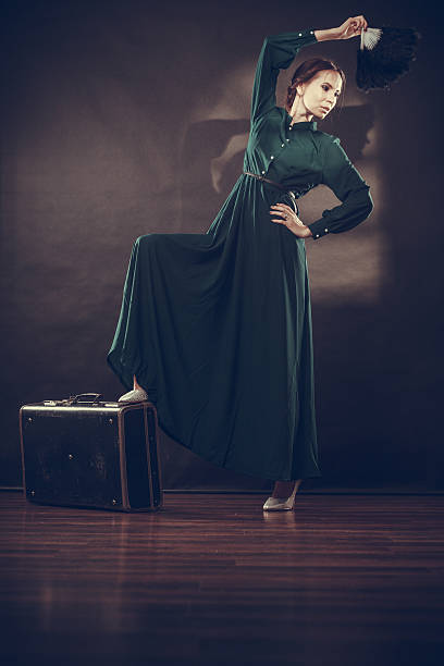istock Woman retro style with old suitcase and fan 638119148