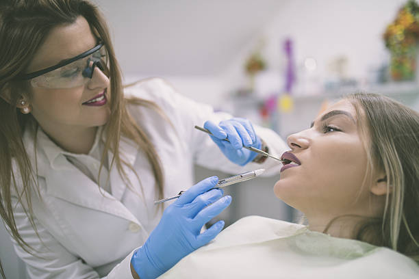 istock dentist holding a syringe and anesthetizing his patient 638119548
