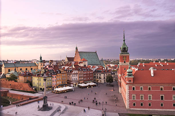 Warsaw, Poland - September 26, 2016: People walking on the Castle Square in the Old Town in Warsaw. The place is declared Unesco World Heritage Site.