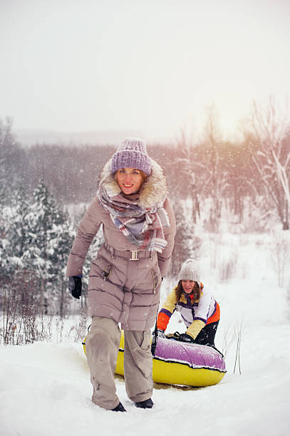 istock Two female friends having fun on snow hill 638119788