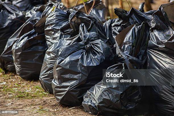 Black Complete Tied Garbage Bags Standing Together On Street Stock Photo - Download Image Now