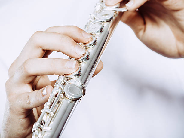 istock Hands of young man playing the flute 638119914
