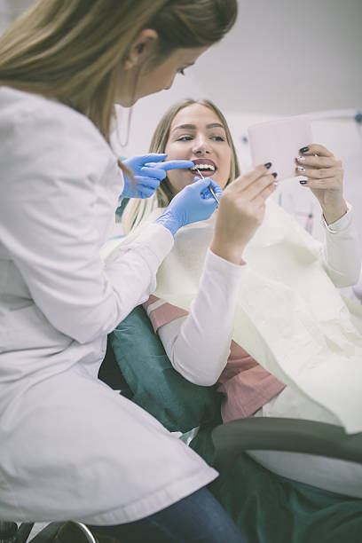 istock Dentist curing a female patient 638121126