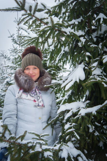 istock woman at the winter tree 638124332