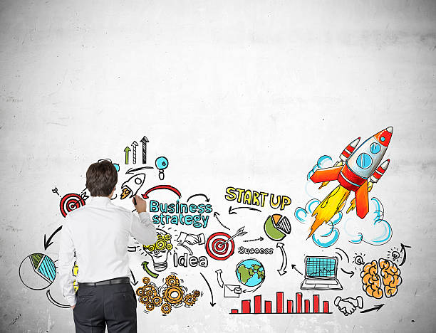 istock Rear view of businessman drawing rocket sketch 638124360