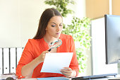 Businesswoman examining a contract meticulously