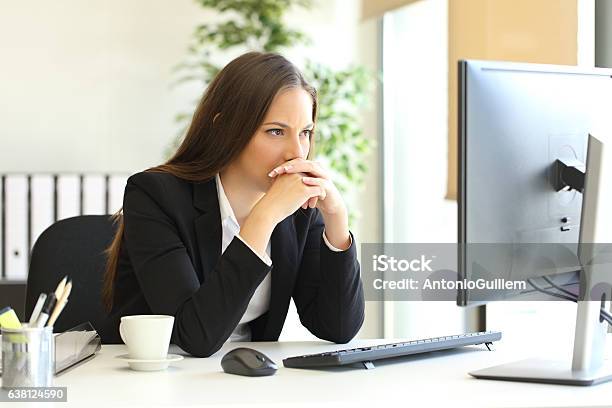 Businesswoman Solving A Difficult Assignment Stock Photo - Download Image Now - Suspicion, Office, Worried