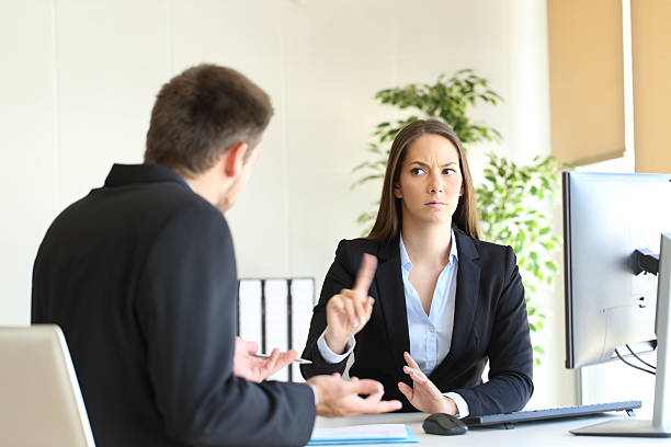 Boss denying something to an employee Boss denying something saying no with a finger gesture to an upset employee in her office rudeness stock pictures, royalty-free photos & images