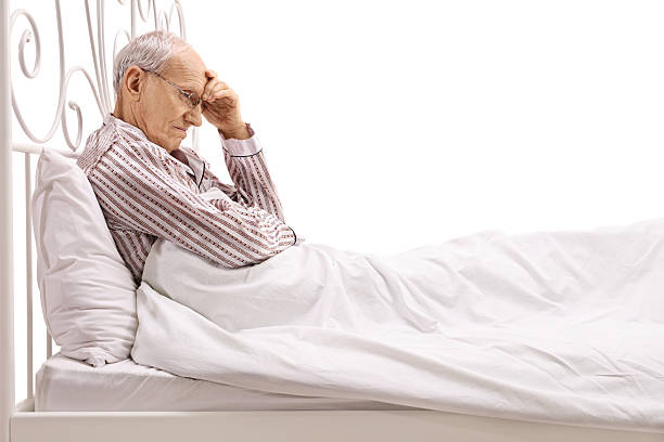 istock Worried senior lying in bed 638126162