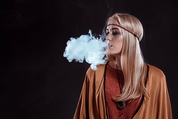 istock Girl in the Boho style blowing smoke 638128488