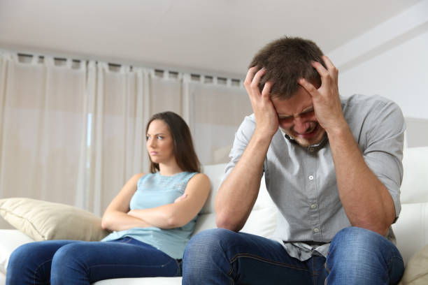 istock Sad man and angry girlfriend at home 638132174