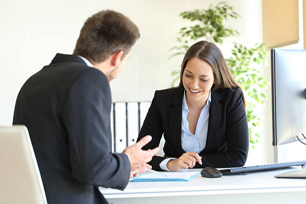 istock Salesman selling to a client at office 638132224