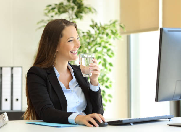 istock Businesswoman drinking water at office 638132538