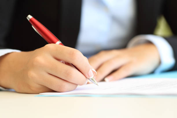 istock Businesswoman hands writing in a document 638132602