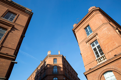 Facade of red brick building on place du Capitole, Toulouse, France