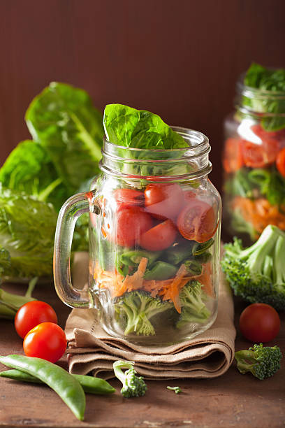 istock healthy vegetable salad in mason jar. tomato broccoli carrot pea 638133614