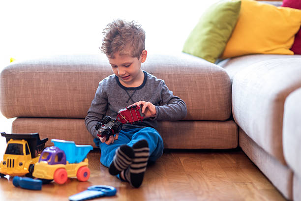 istock Little boy playing with toys 638136236
