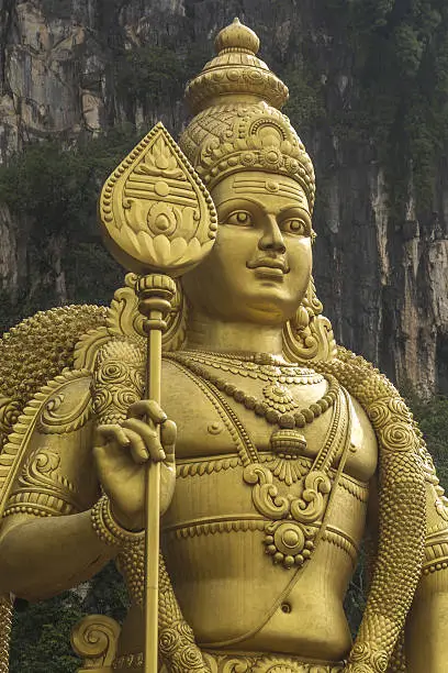 The giant, golden Statue of hindu god Muragan at Batu caves, Kuala-Lumpur