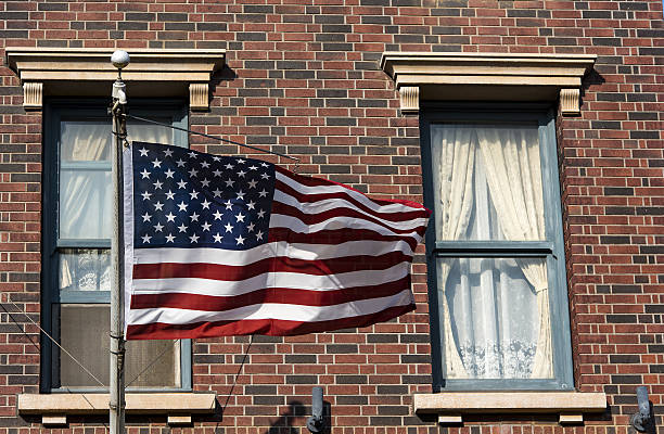 istock American flag in front of a city 638139614
