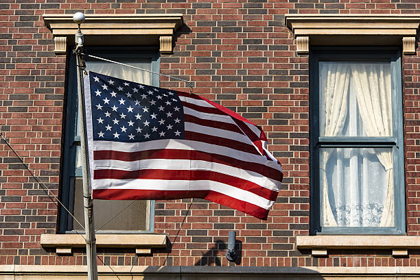 istock American flag in front of a city 638139672