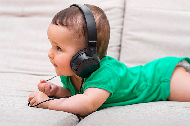 istock Cute baby with headphones 638143060