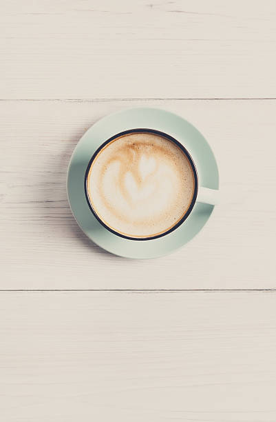 istock Cappuccino foam, coffee cup top view on white wood background 638143466