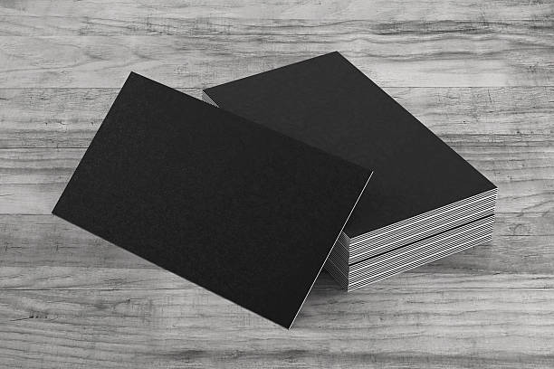Black business cards on on wood background