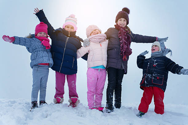 istock Medium group of  children standing in the snow. 638149160