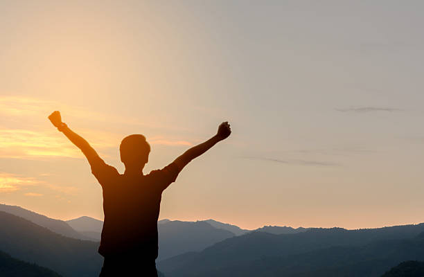 istock Man Silhouette  Raised Up hands with Sunrise 638151178