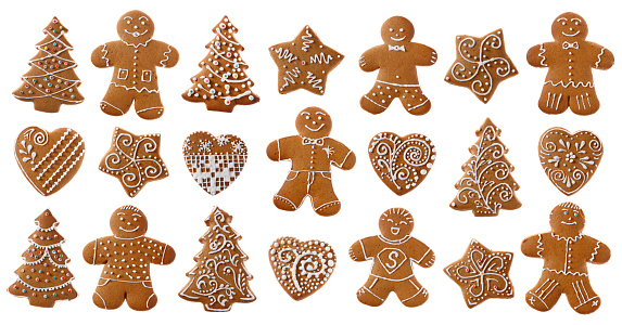 Gingerbread cookies with different figures on a wooden table. Christmas dessert.