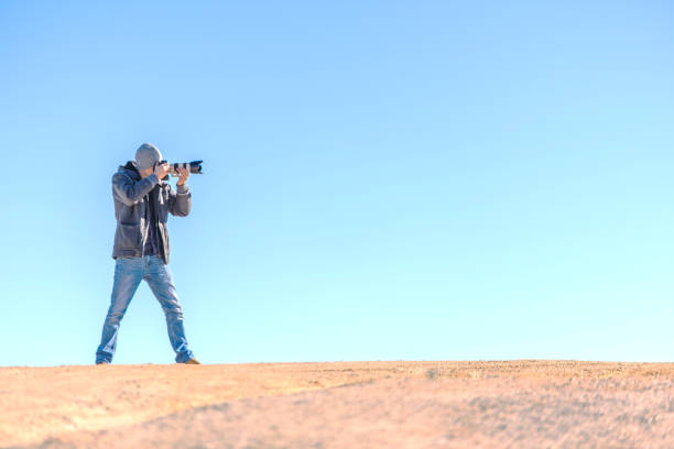 istock Young proffessional photographer taking pictures side view 638157908