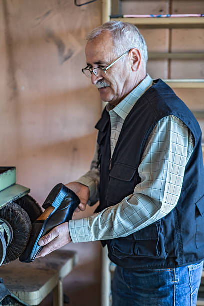 istock Shoemaker polishing shoes 638159228