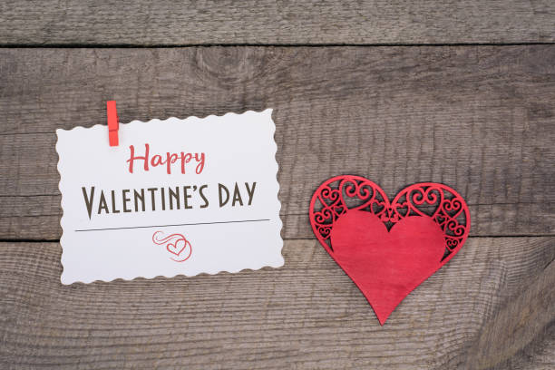 istock Valentine's card. Red felt heart on wooden board. 638160902