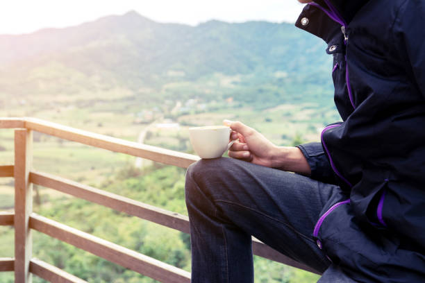 istock Man Sitting with Coffee Cup at View Point 638161916