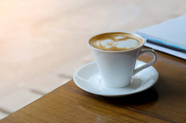istock White Coffee Cup on Wood Desk in Morning 638162436