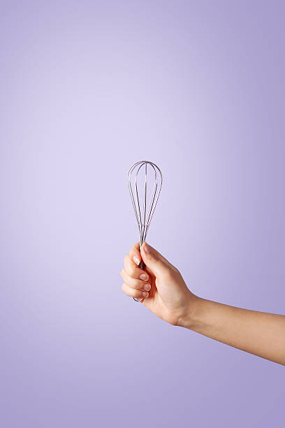 istock Woman hand holding a whisker on violet background 638163598