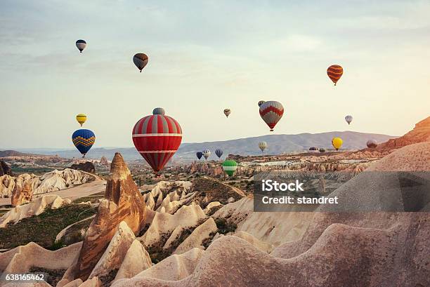 Hot Air Balloon Flying Over Rock Landscape At Cappadocia Turkey Stock Photo - Download Image Now