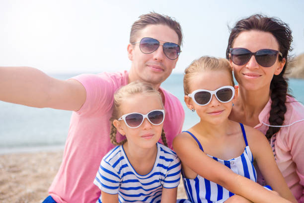 istock Young beautiful family taking selfie on the beach 638167286