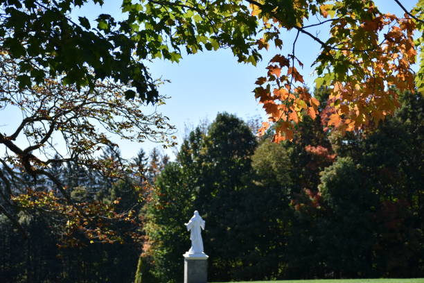 istock Jesus Christ statue in a beautiful fall nature scene 638170812