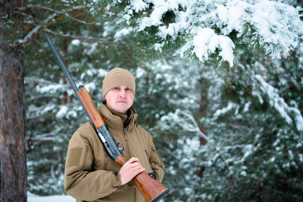 istock Hunter man dressed camouflage clothing standing in the winter 638170978