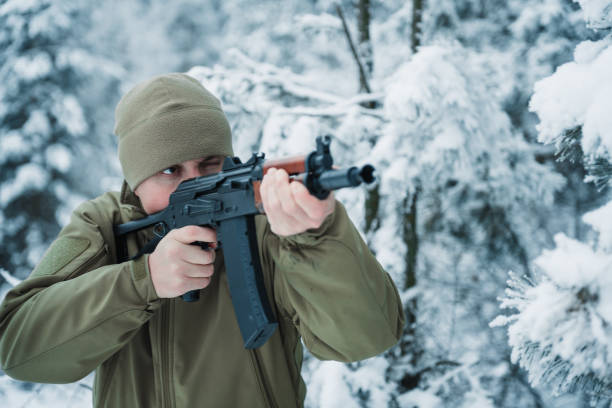istock Hunter man dressed camouflage clothing standing in the winter 638171572