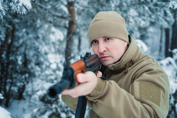 istock Hunter man dressed camouflage clothing standing in the winter 638171626