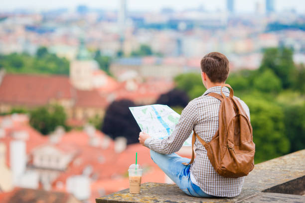 istock Young man with a city map and backpack background european 638172802
