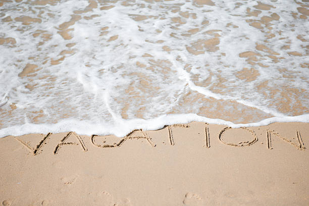 istock Vacation written on tropical beach white sand 638177916