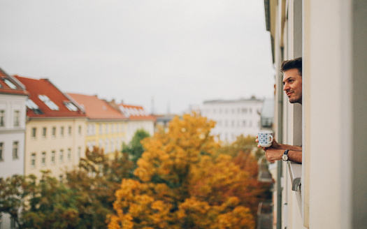 Man looking through the apartment window in Berlin Prenzlauer Berg